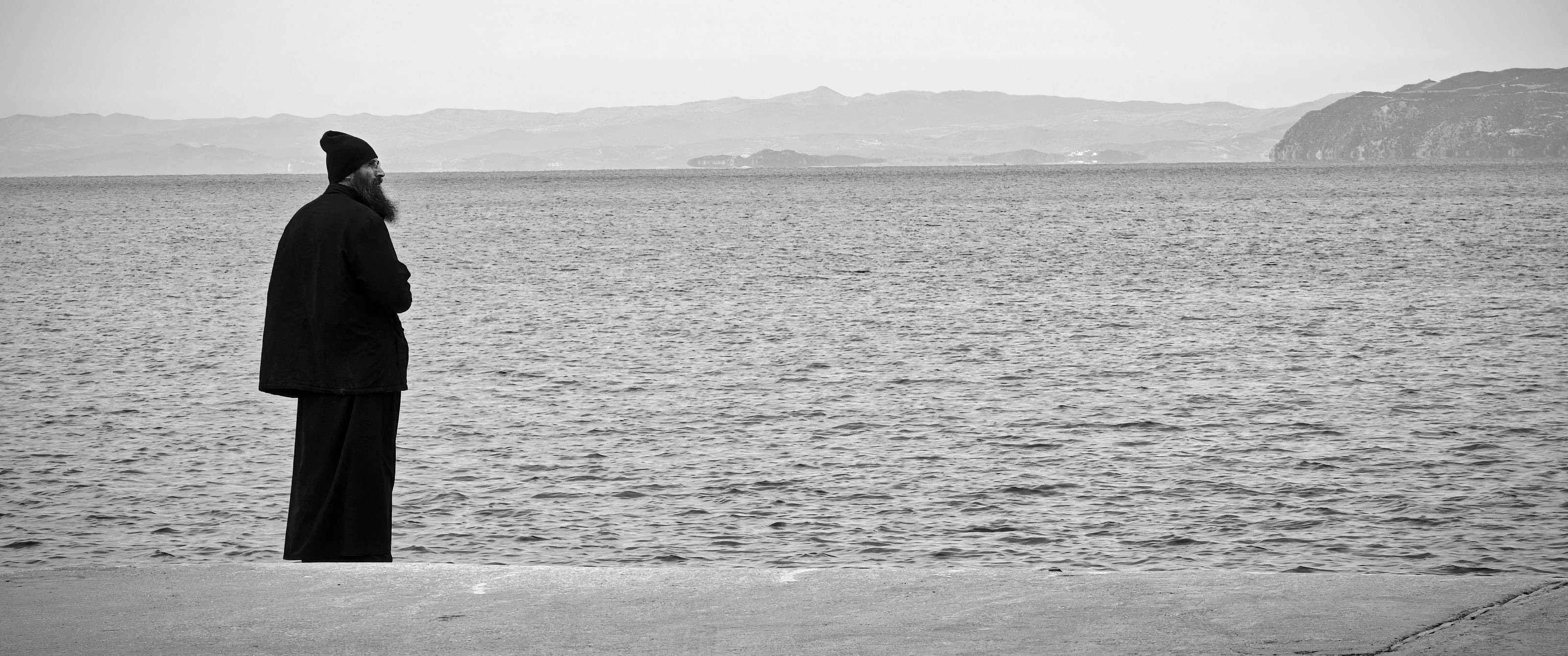 A monk looking across the water from Mount Athos