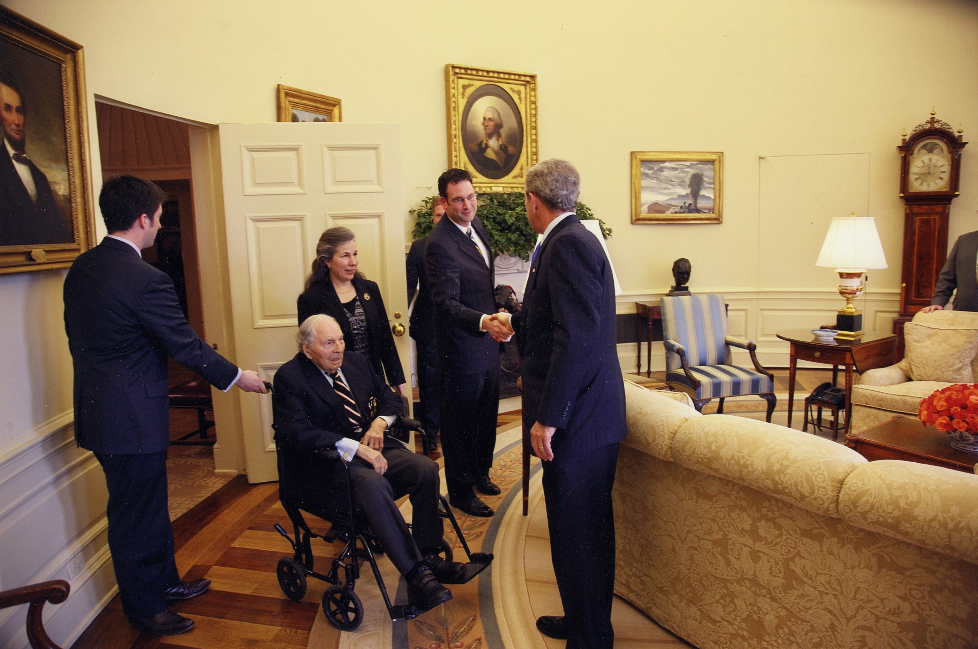 David DeJonge greeting President George W. Bush in the Oval Office as Frank and Susannah Buckles look on, March 6, 2008