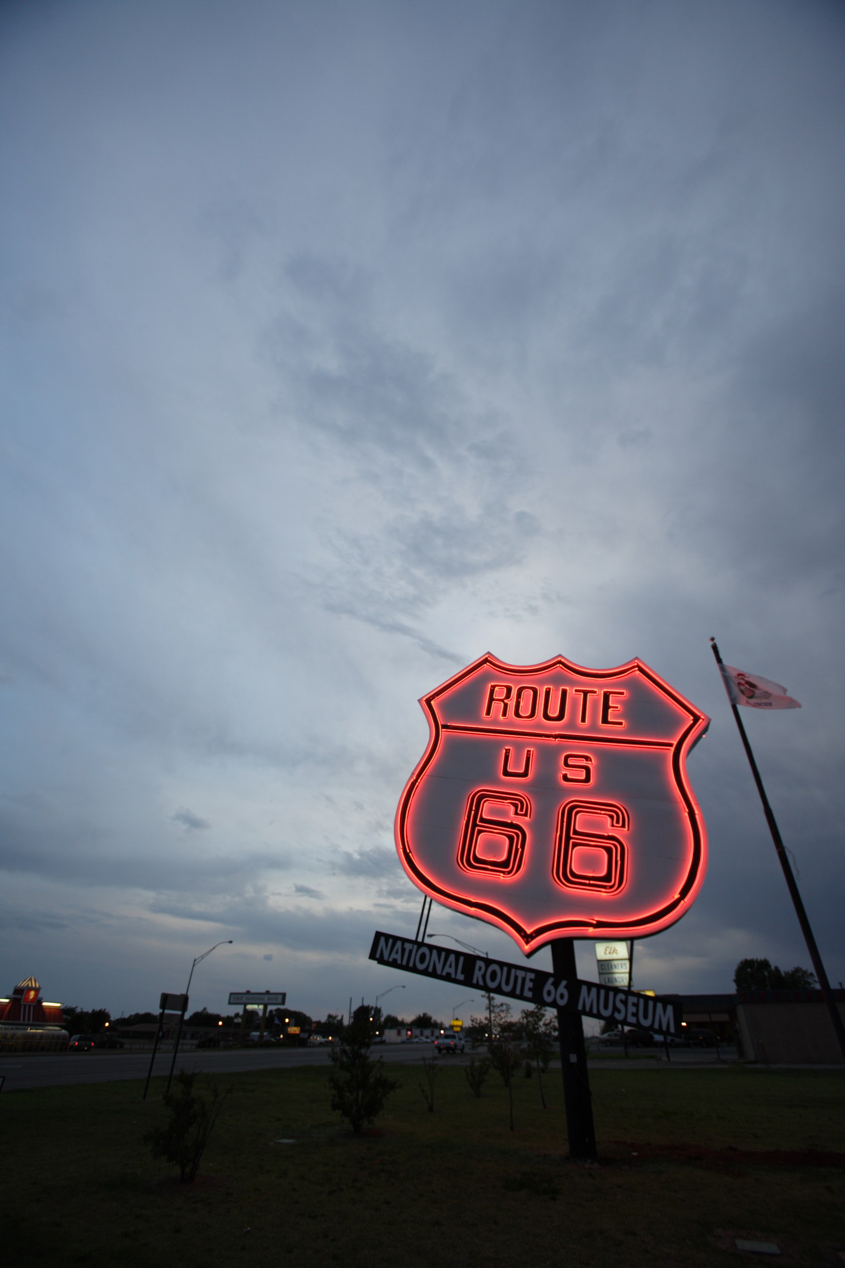 A Route 66 sign at dusk